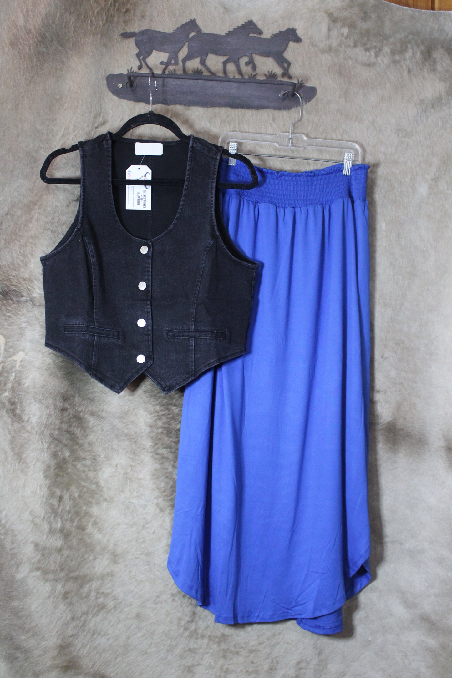 Stylish black denim vest women displayed with a flowing blue skirt for a trendy outfit combination