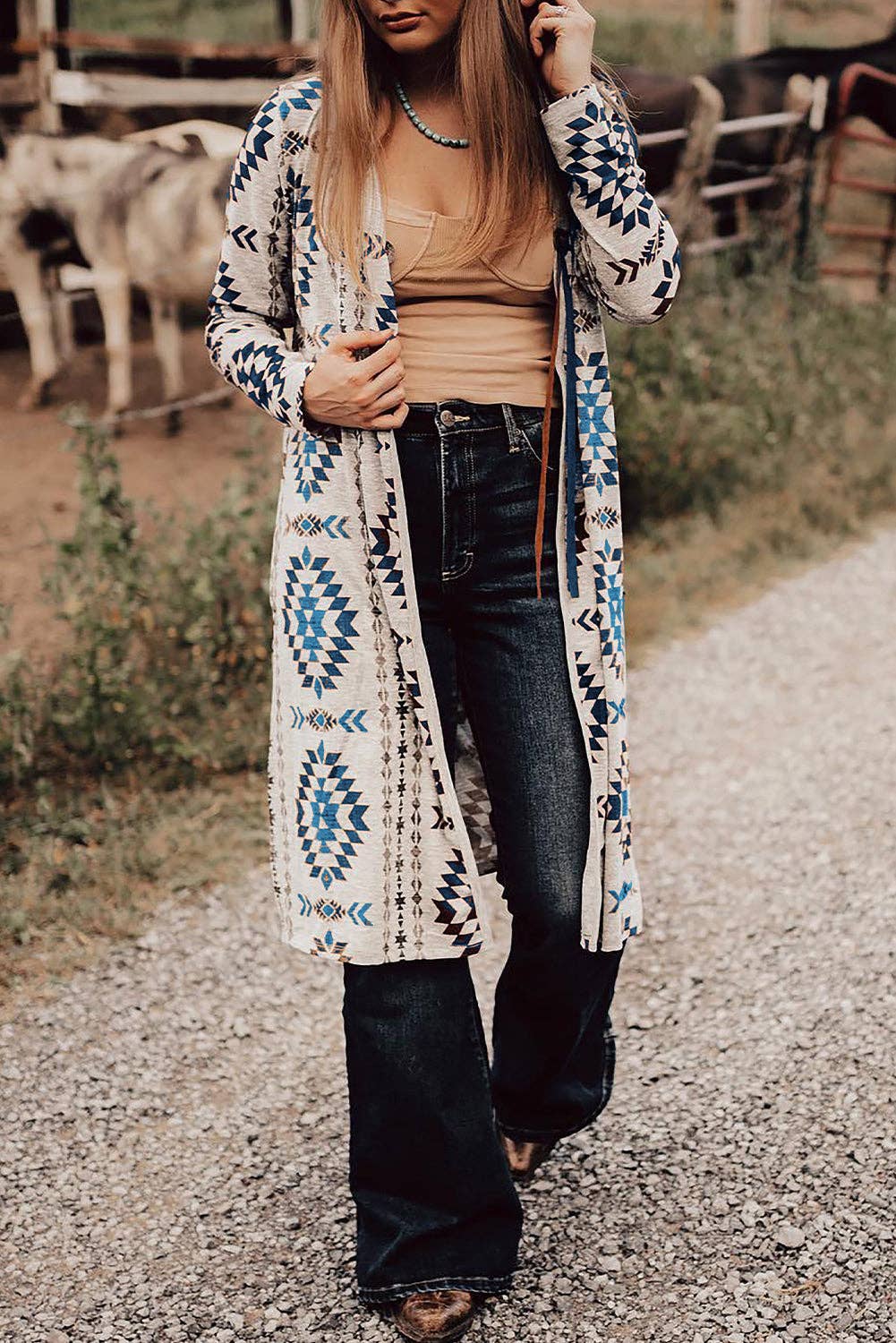 Blue Aztec cardigan women styled with a tan top and flared jeans for a trendy look