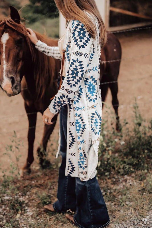 Blue Aztec cardigan women styled with flared jeans and a horse in a rustic setting
