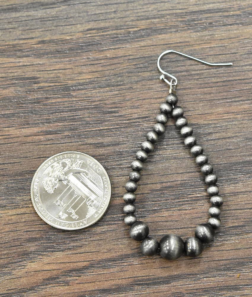 Handmade Navajo bead earrings featuring a unique teardrop design with silver-tone beads