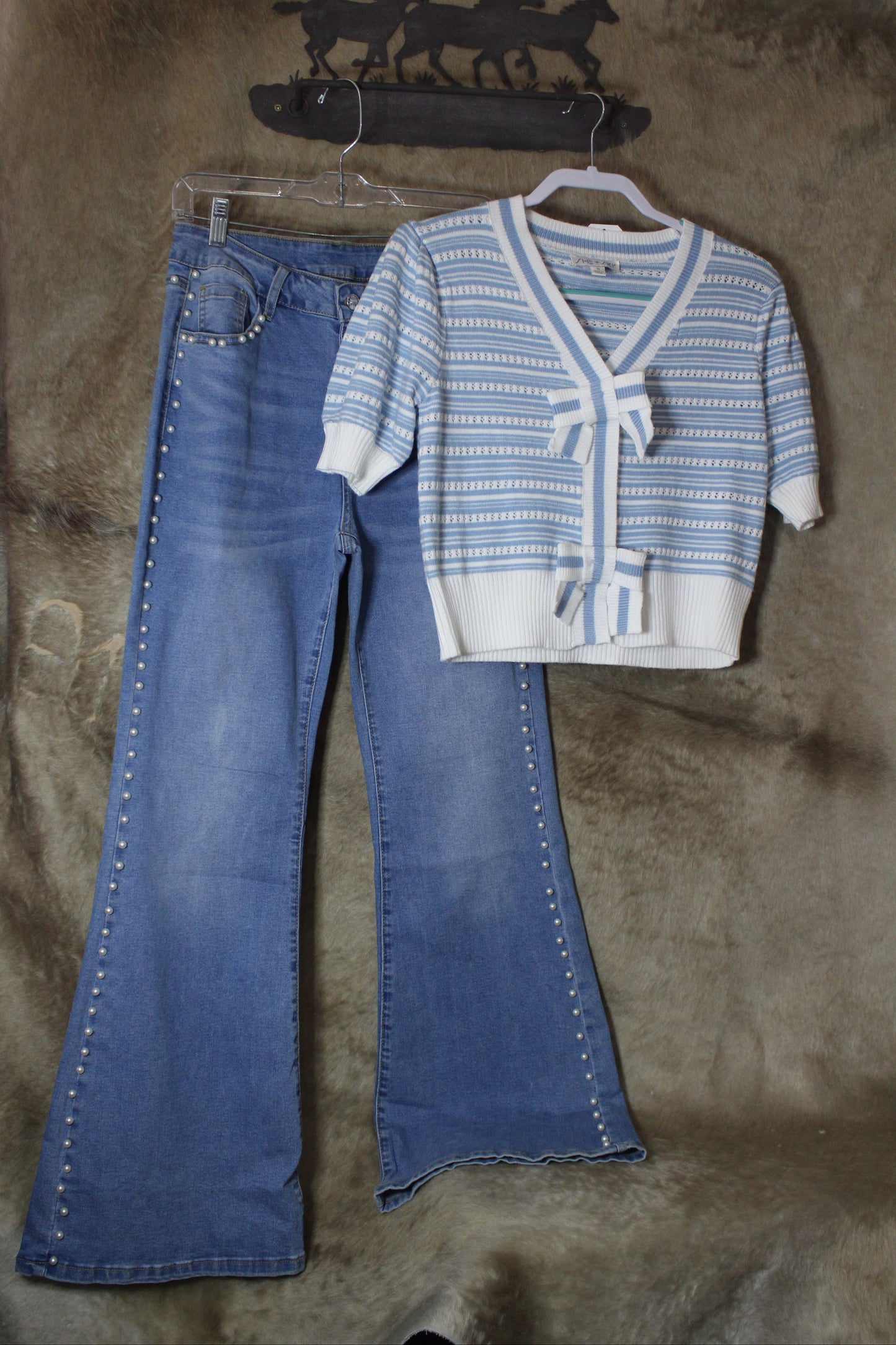 SHE+SKY puff sleeve bow cardigan in blue and white stripes, paired with stylish flared jeans