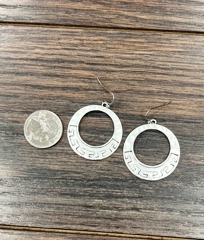 Silver ranch style earrings with intricate design, shown next to a quarter for size comparison