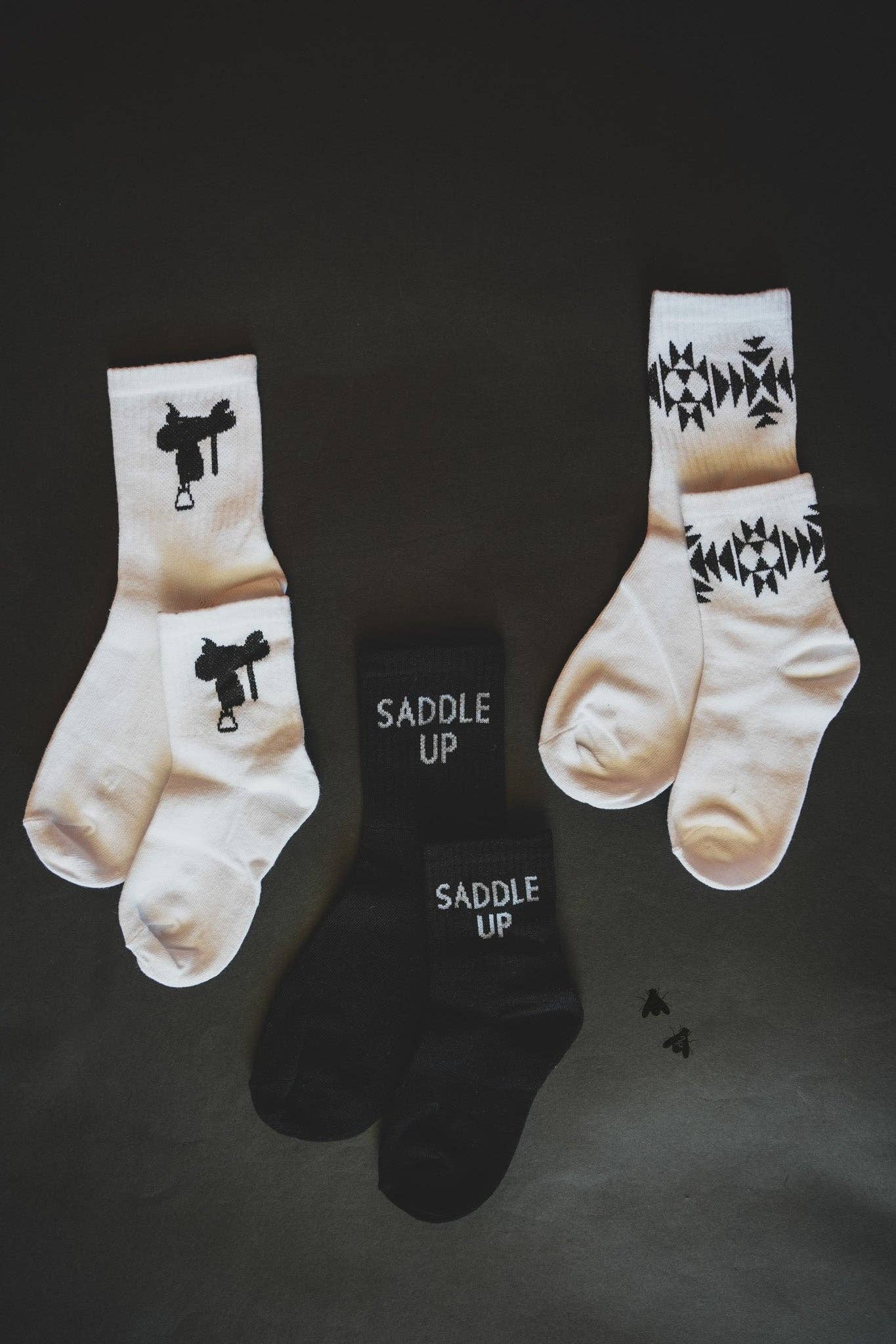 Sock Em Silly Saddle Mono Kids Socks in white and black with playful designs for children