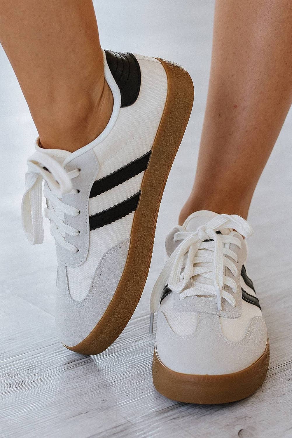 Aapparella striped lace-up sneakers in grey and white with black stripes and gum sole.