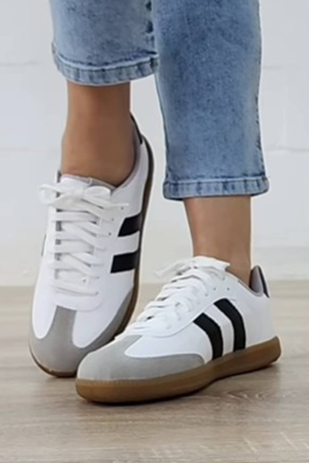 Aapparella striped lace-up sneakers in white and black with a stylish design and comfortable fit
