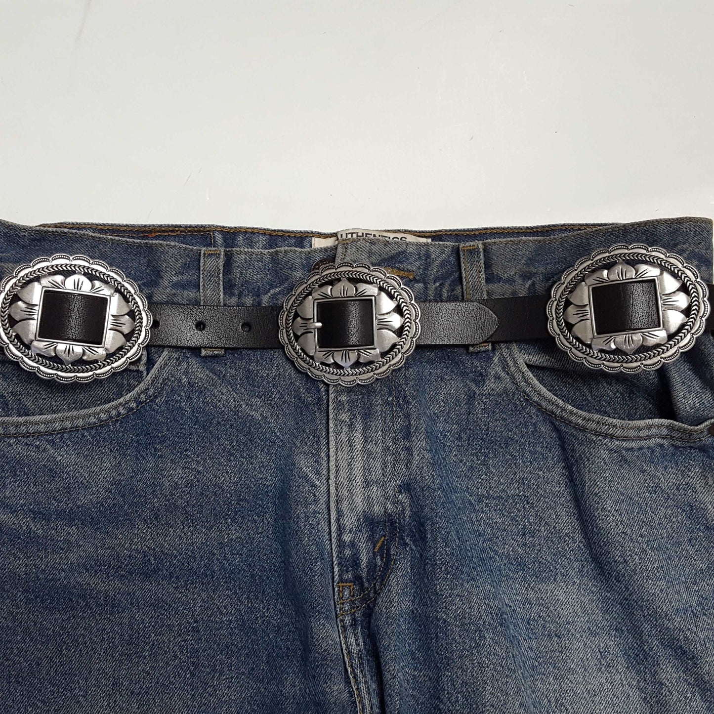 The Lainey High Rise Super Flare jeans styled with a decorative silver buckle belt for a trendy look
