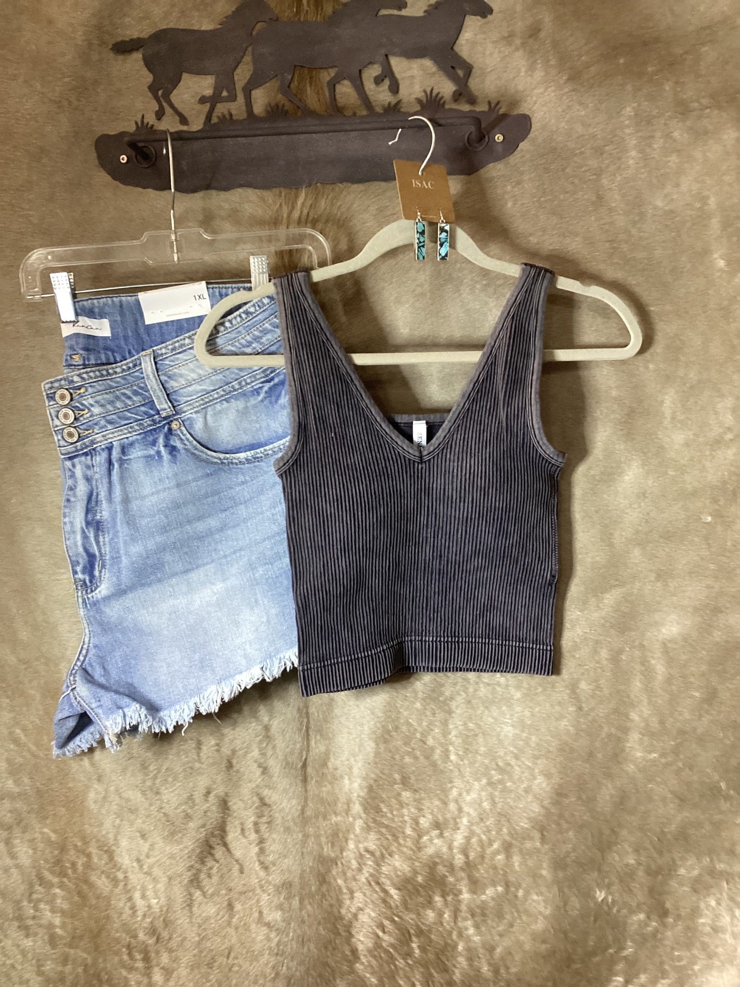 Zenana Women's ribbed tank top in black paired with denim shorts on a clothing rack