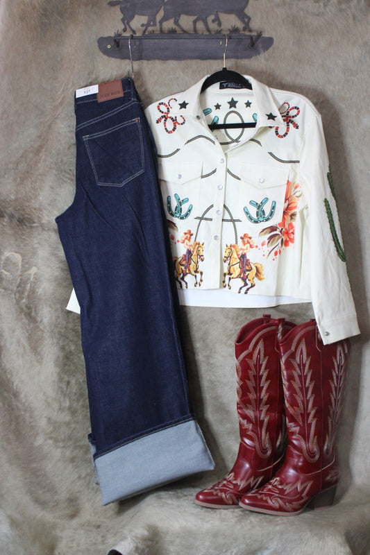 Vintage style high waist jeans displayed with a western-style shirt and red cowboy boots