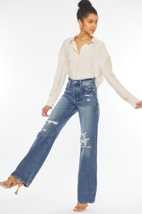 Stylish KanCan high-waisted jeans paired with a cream blouse, perfect for Montana boutique clothing lovers