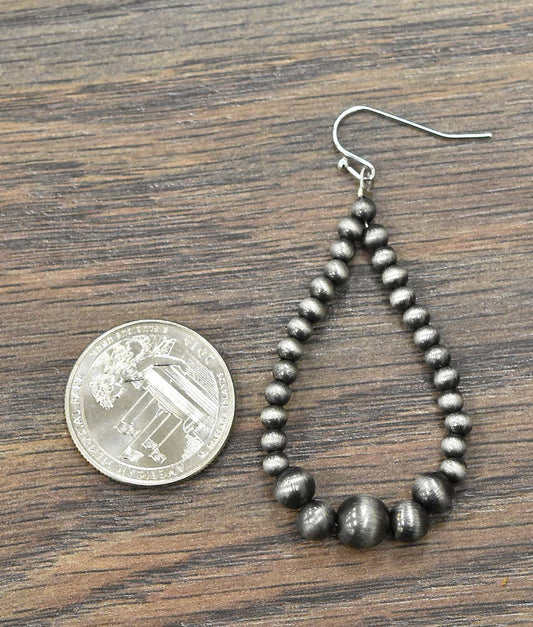 Handmade Navajo bead earrings featuring a unique teardrop design with silver-tone beads