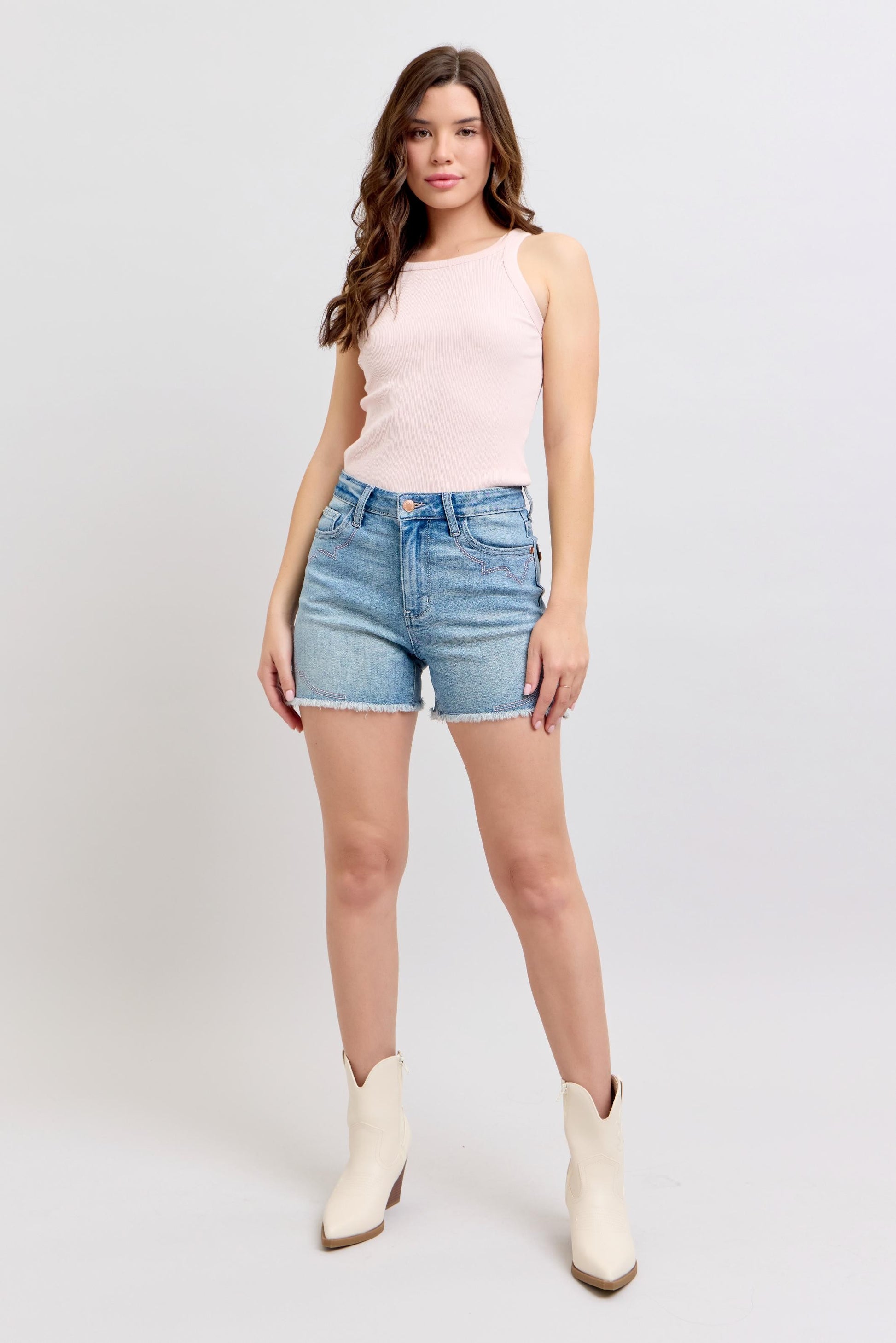 Stylish Judy Blue denim shorts with a classic fit, paired with a pink top and white ankle boots