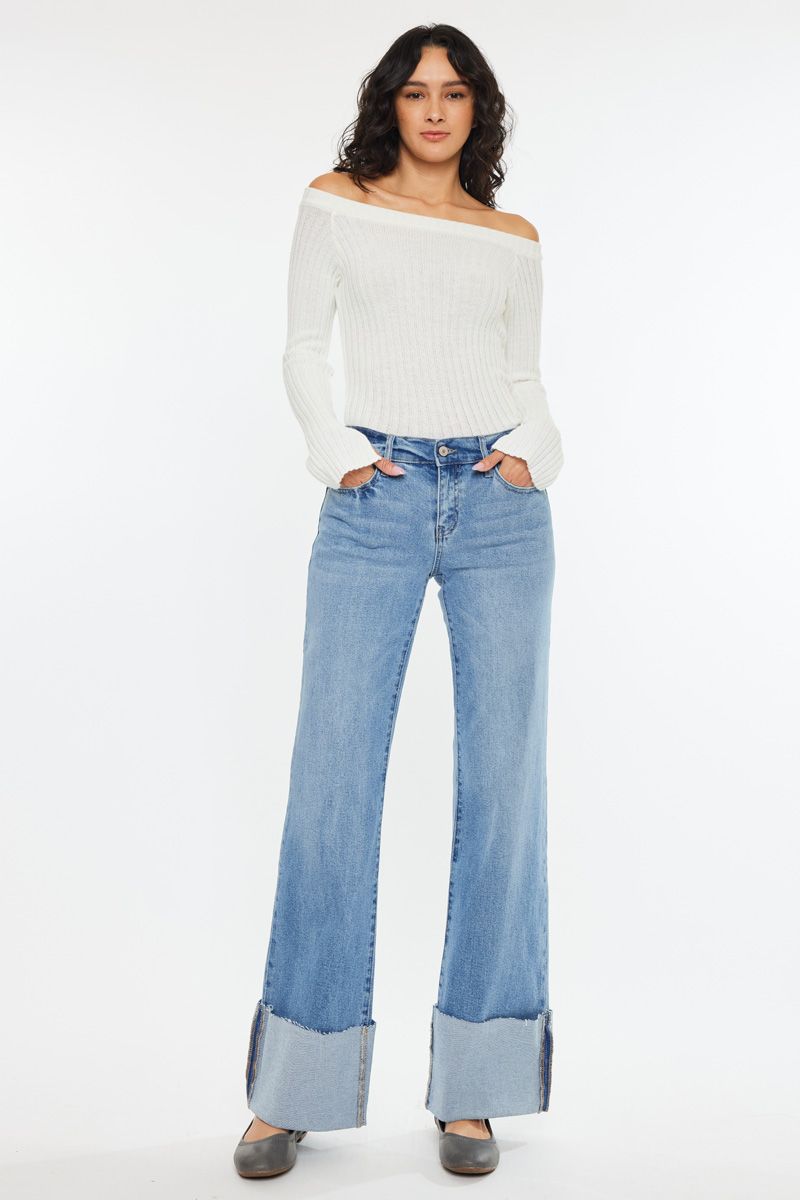 Woman wearing KanCan light wash cuff jeans with a stylish off-shoulder white sweater