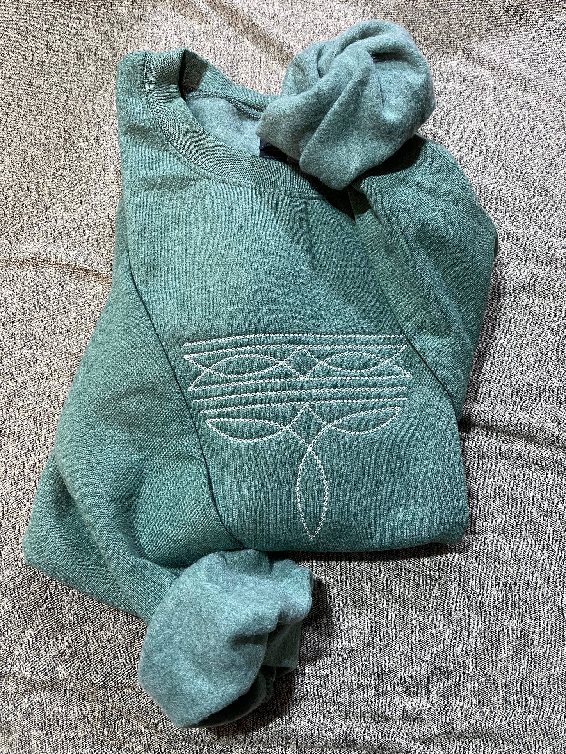 Basil & Burch ranch style boot stitch sweater in teal with unique embroidered design