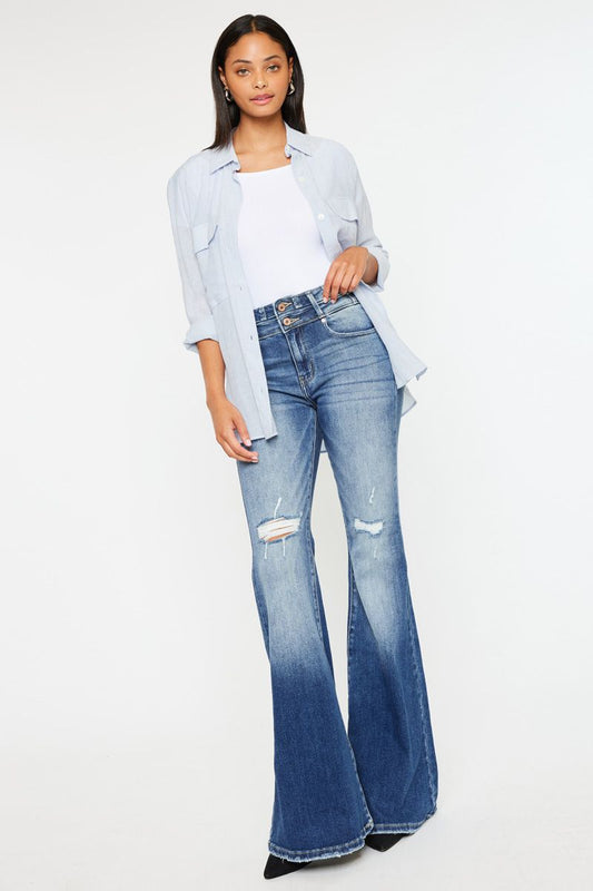 Woman modeling The Lainey High Rise Super Flare jeans with a stylish top and heels for a chic look